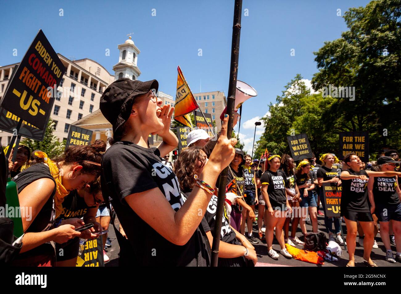 Washington, DC, USA, 28 June, 2021.  Pictured: Protesters cheer outside the White House as others complete a street mural demanding that Biden not compromise their futures in addressing climate change.  Protesters are young adults who are members of the Sunrise Movement.  They have 3 demands of the Biden Administration: no compromises on climate with Congressional Republicans, a meeting with Sunrise Movement, and the creation of a Civilian Conservation Corps.  Credit: Allison Bailey / Alamy Live News Stock Photo