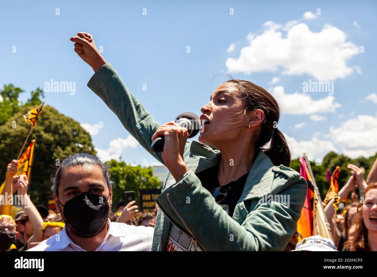 Washington, DC, USA, 28 June, 2021.  Pictured: Congresswoman Alexandria Ocasio-Cortez (D-NY) speaks to hundreds of protesters in Lafayette Square in front of the White House.  Protesters are young adults who are members of the Sunrise Movement.  They have 3 demands of the Biden Administration: no compromises on climate with Congressional Republicans, meeting with Sunrise Movement, and the creation of a Civilian Conservation Corps.  Credit: Allison Bailey / Alamy Live News Stock Photo