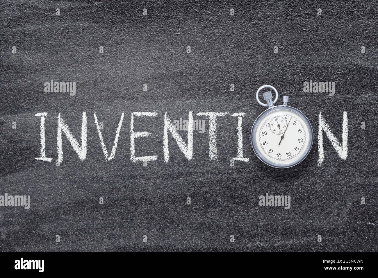 invention word written on chalkboard with vintage precise stopwatch Stock Photo