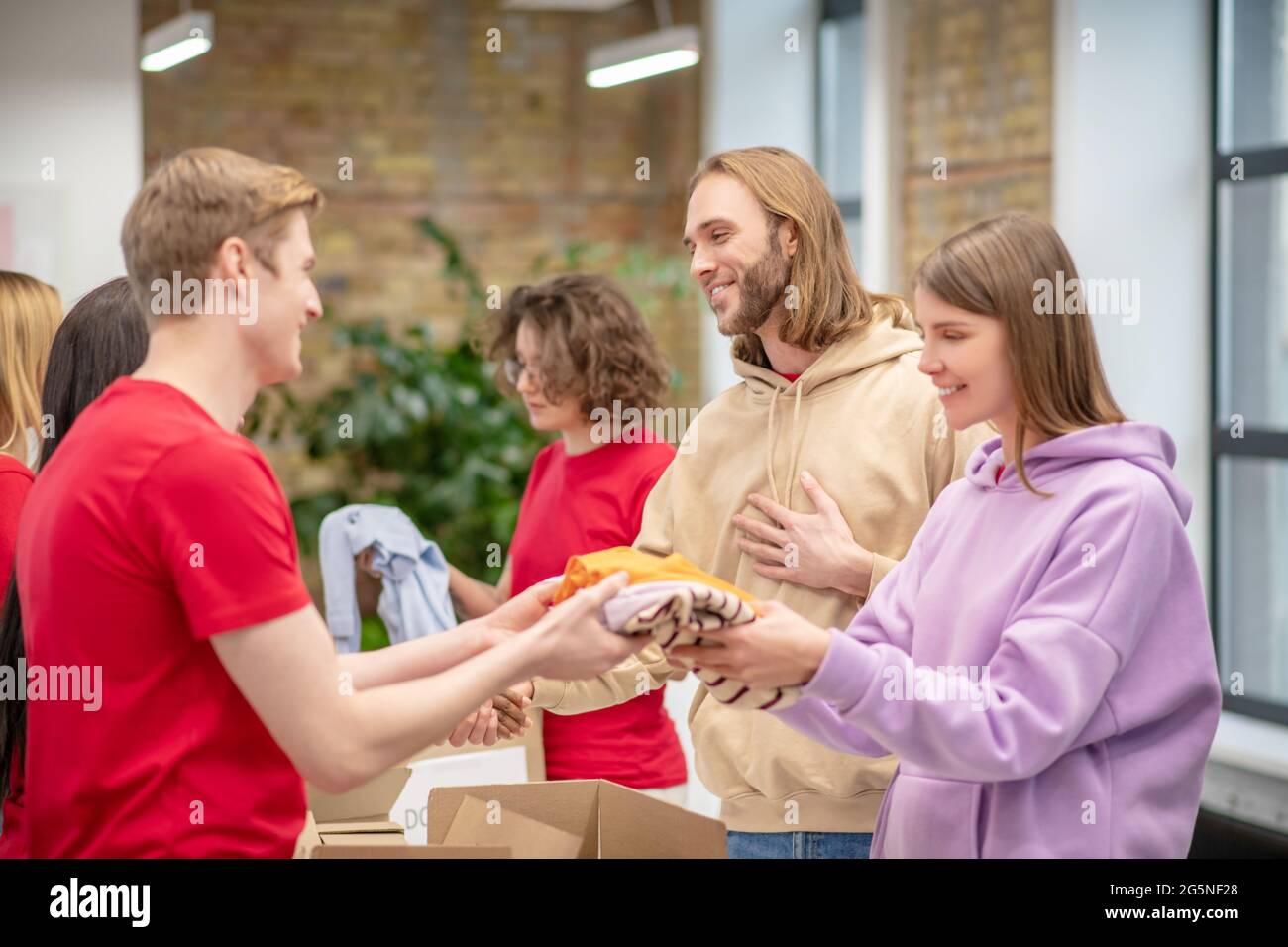 Volunteers giving charitable aid to those in need Stock Photo