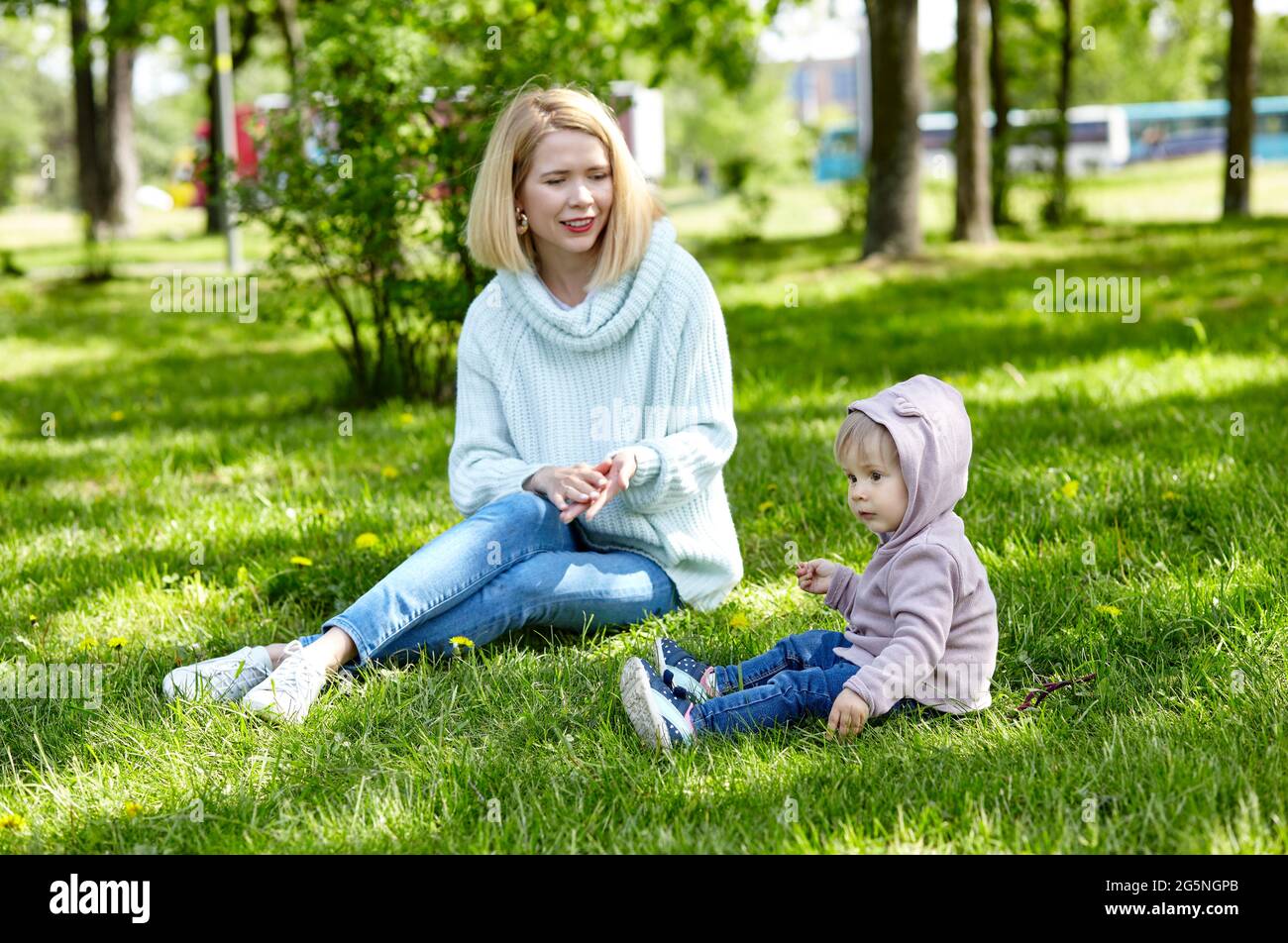 Mom and daughter on nature walk at spring park. Little girl and mother have a good time on weekend activity Stock Photo