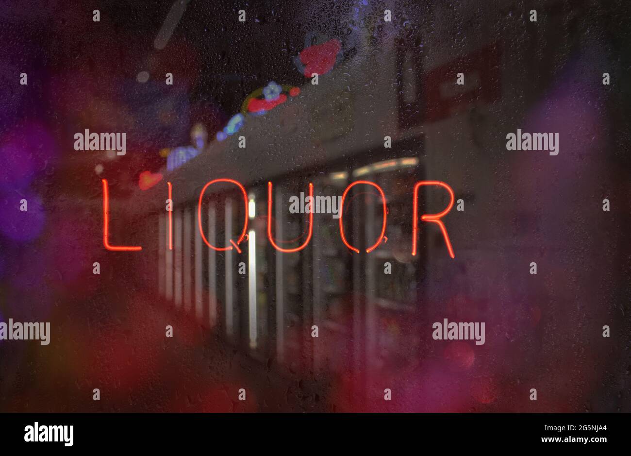 Neon Liquor Sign in Wet Window Stock Photo Alamy