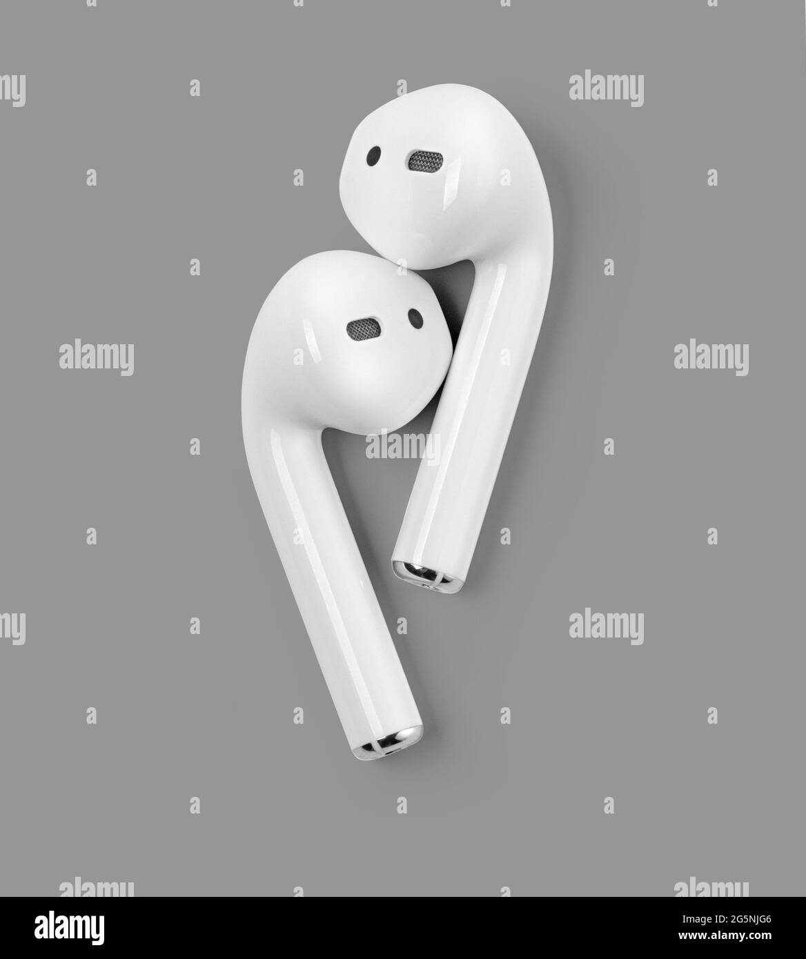 White headphones wireless earphones . White headphones wireless earphones on grey background with clipping path. Stock Photo