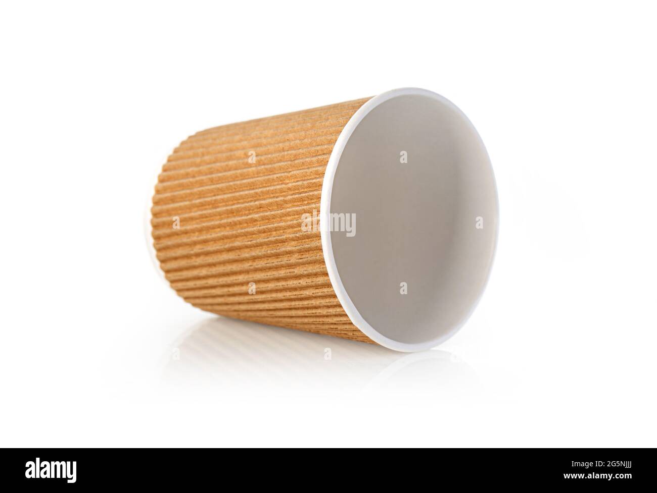 a paper coffee cup sits on a white table Stock Photo
