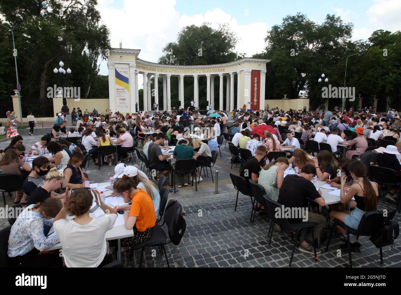 DNIPRO, UKRAINE - JUNE 28, 2021 - People do Ukrainian dictation outdoors in Tarasa Shevchenko Square in celebration of the 25th Consitution Day, Dnipr Stock Photo