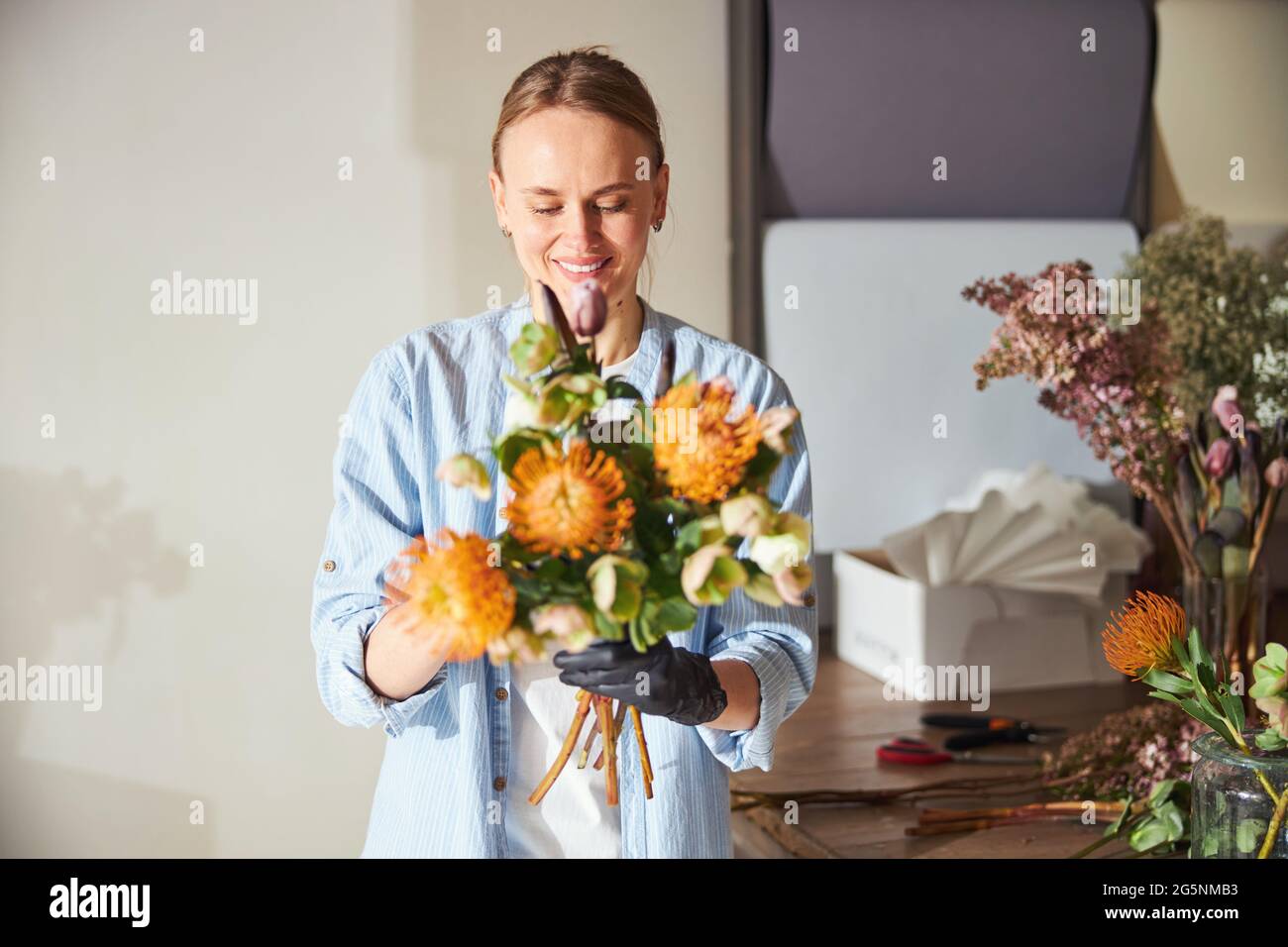 One woman admiring flowers hi-res stock photography and images - Alamy