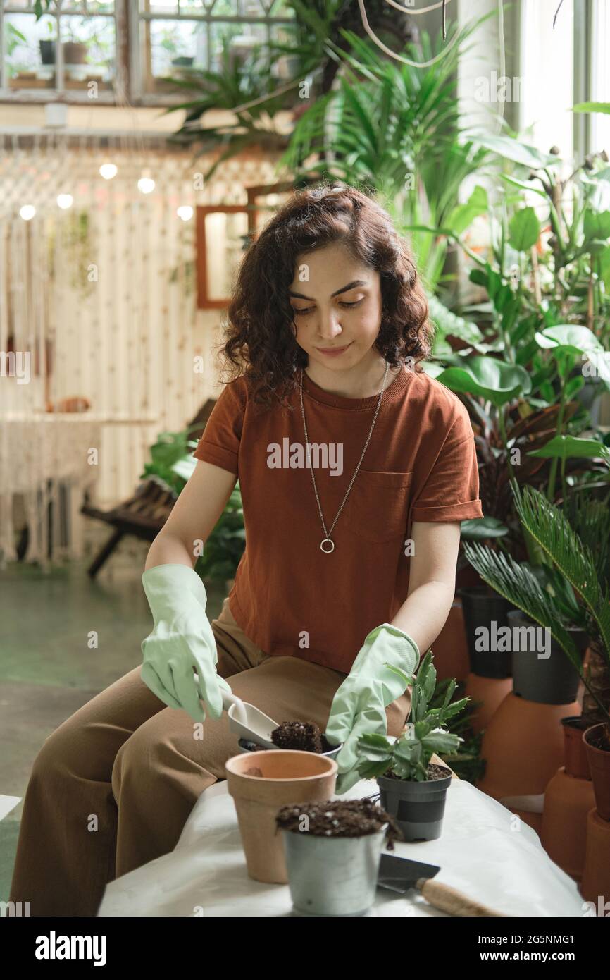 Smiling young women planting hi-res stock photography and images - Alamy