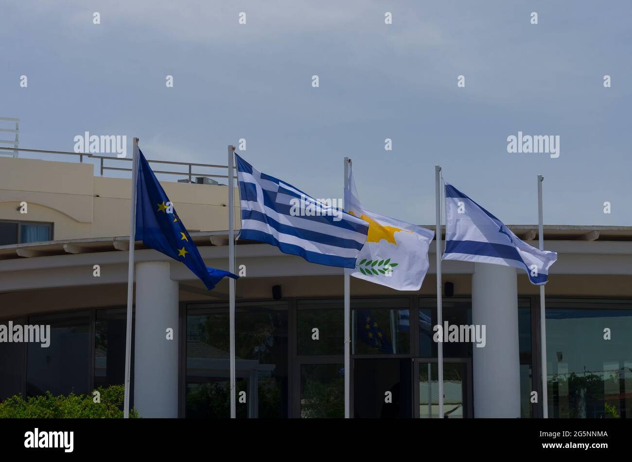 Four national flags with symbols of the European Union, Greece, Cyprus and Israel Stock Photo