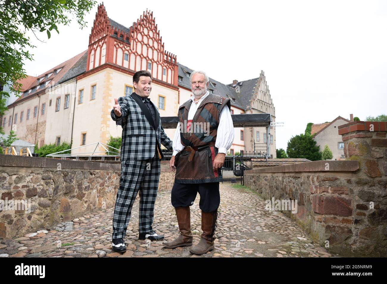 Grimma, Germany. 29th June, 2021. Konrad Schöpe (l), musician Firebirds, and Jochen Rockstroh, lord of the castle, stand at a stage in front of Trebsen Castle. From 02 to 04 July 2021, a music festival without distance rules and mask obligation will take place on the grounds of the moated castle as part of a model project. Credit: Sebastian Kahnert/dpa-Zentralbild/ZB/dpa/Alamy Live News Stock Photo