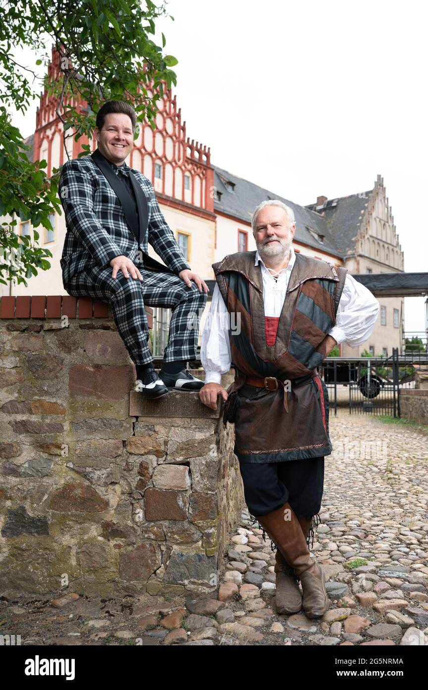 Grimma, Germany. 29th June, 2021. Konrad Schöpe (l), musician Firebirds, and Jochen Rockstroh, lord of the castle, sit or stand at a stage in front of Trebsen Castle. From 02 to 04 July 2021, a music festival without distance rules and mask obligation will take place on the grounds of the moated castle as part of a model project. Credit: Sebastian Kahnert/dpa-Zentralbild/ZB/dpa/Alamy Live News Stock Photo