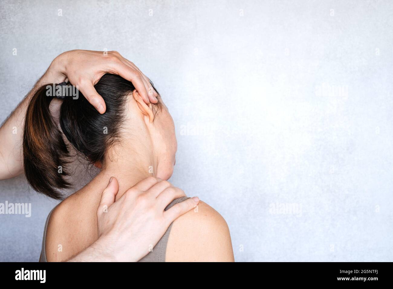 A chiropractor performing a manipulation on woman's neck and