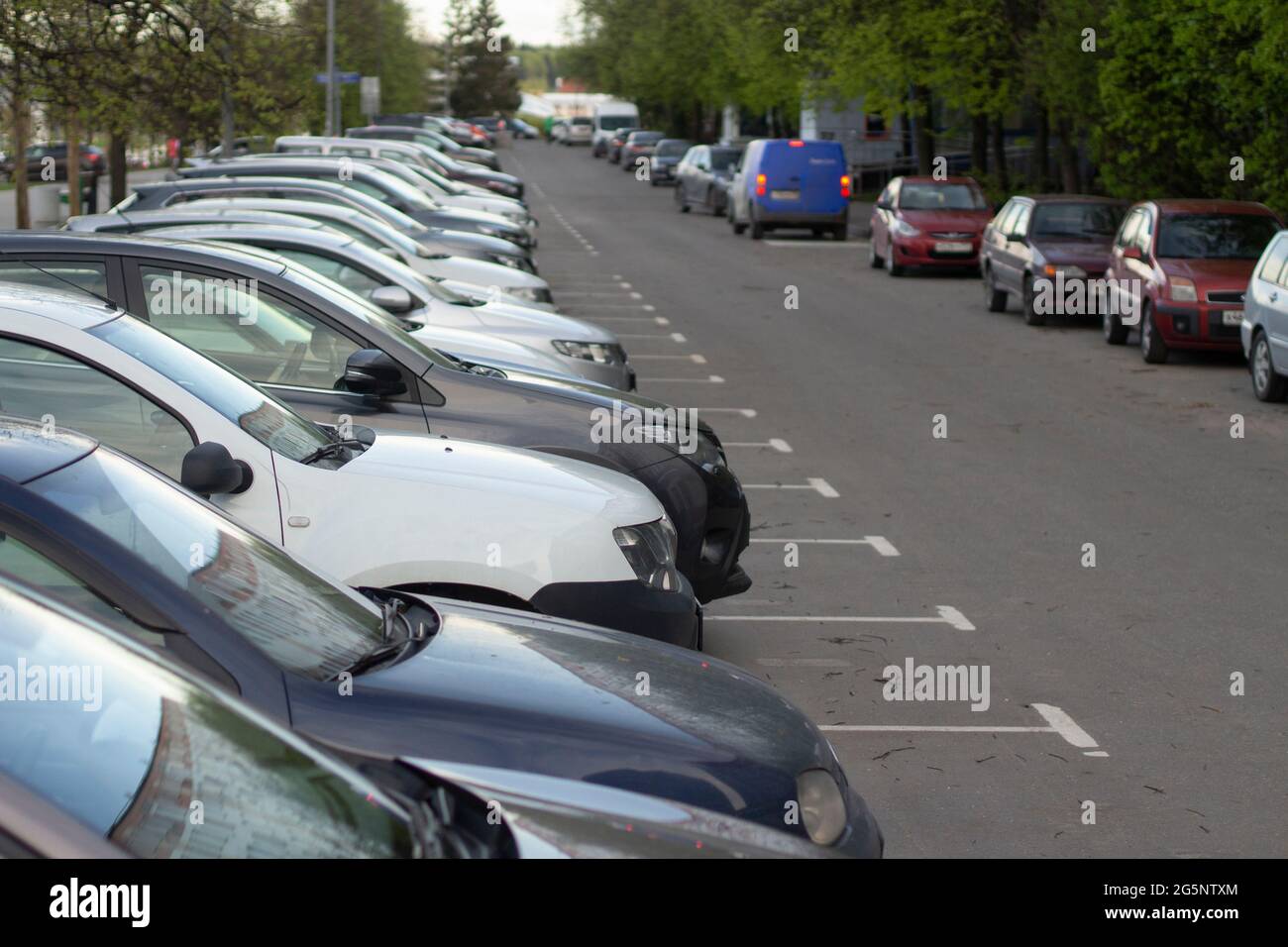 Parking at home. Cars are in a row. Transport in the yard. Car parking