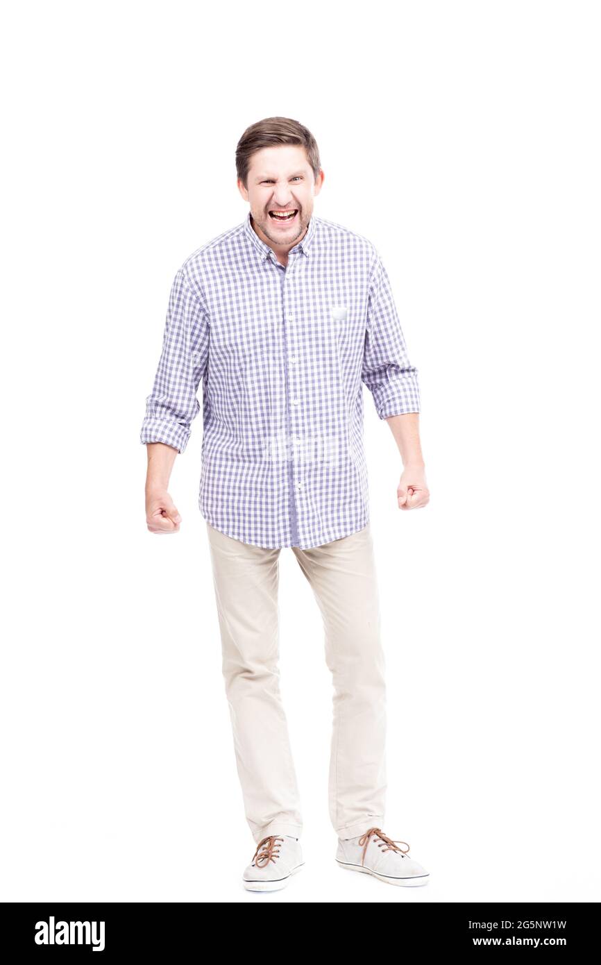 Vertical full length isolated shot of mature Caucasian man getting angry at something, white background Stock Photo