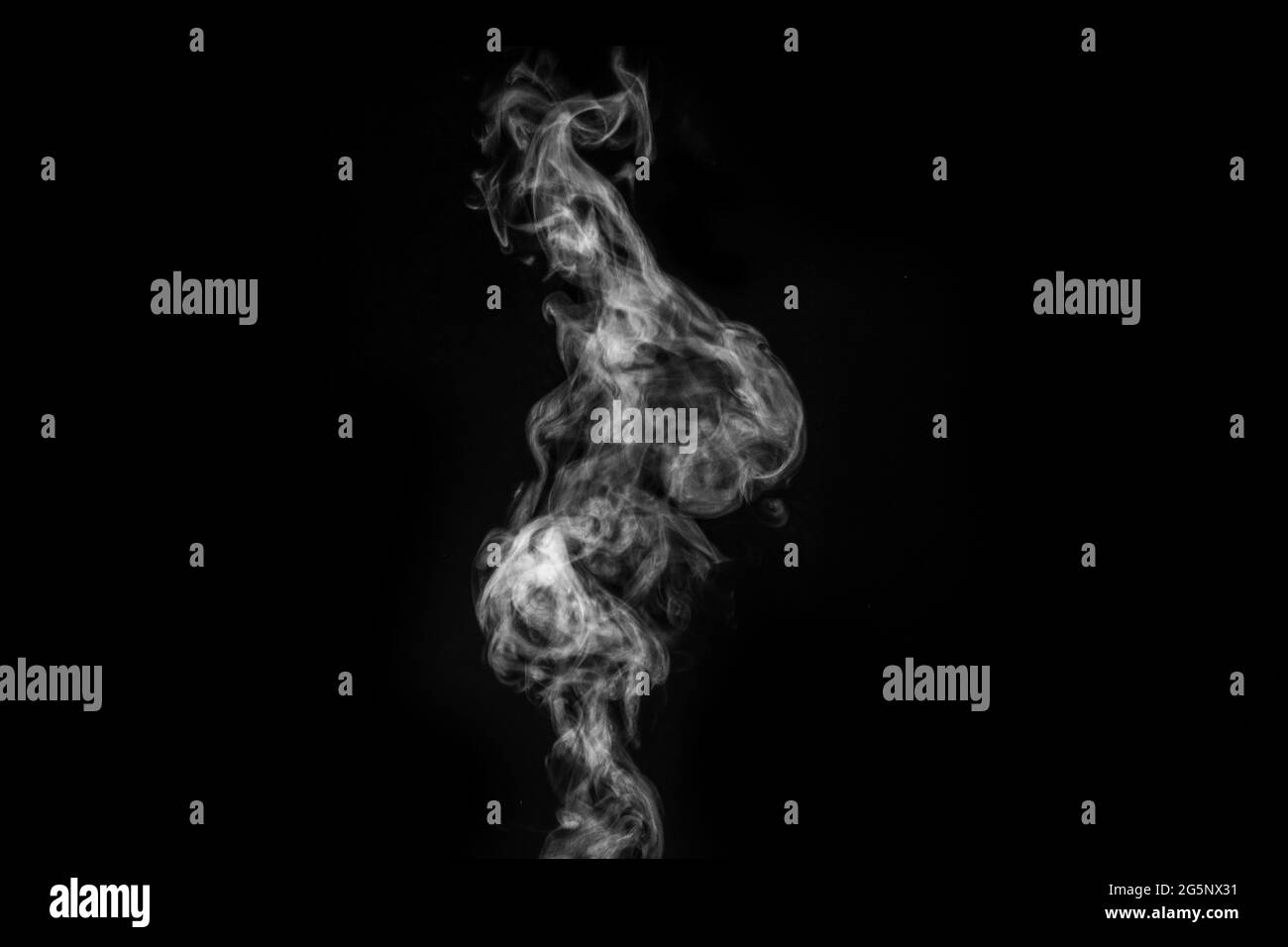 Perfect mystical curly white steam or smoke isolated on black background. Abstract background fog or smog, design element for Halloween, layout for co Stock Photo
