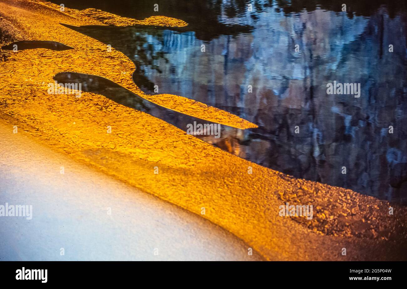 Sun reflecting on show at waters edge Stock Photo Alamy
