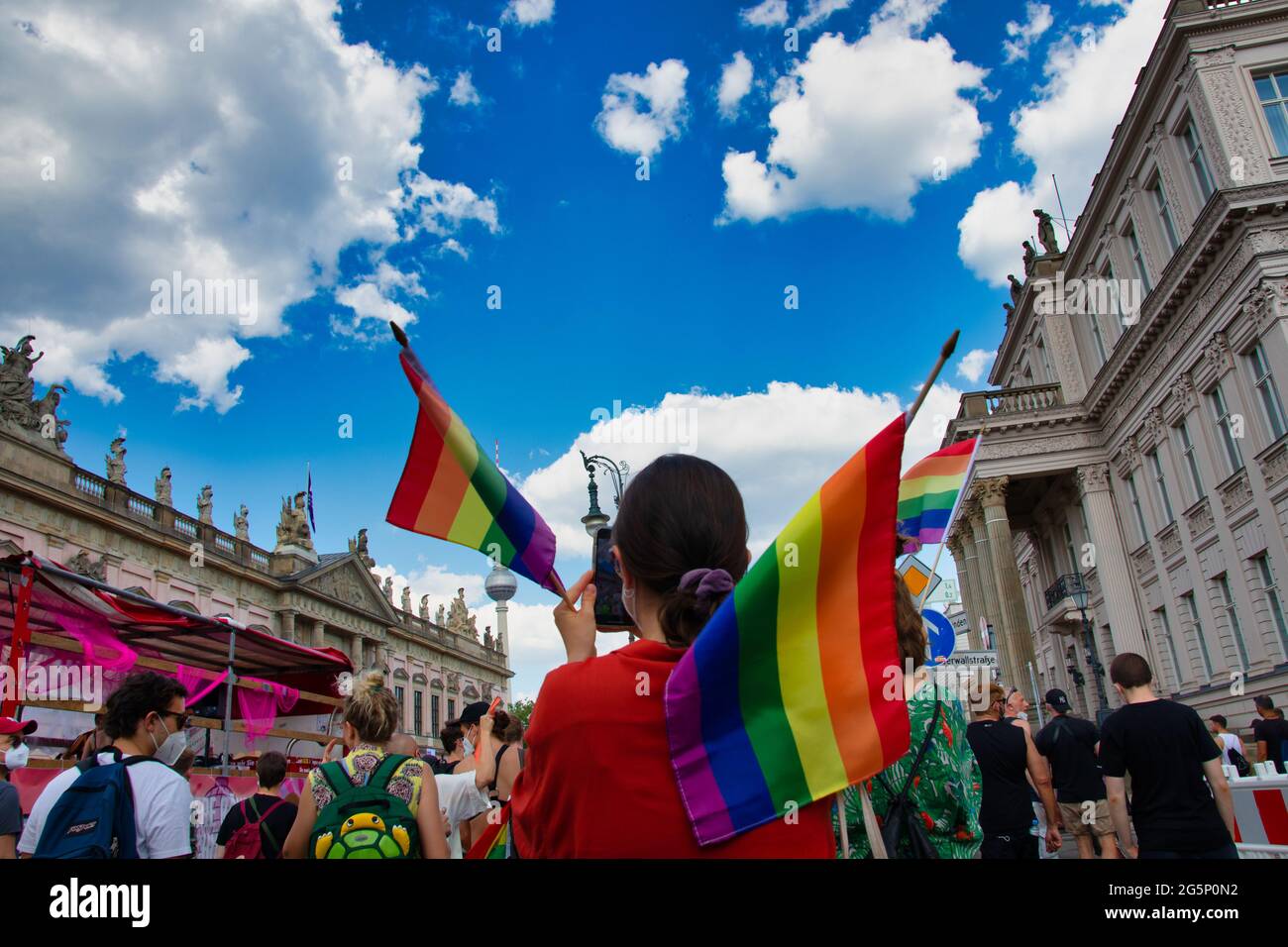 Berlin, Germany - June 26, 2021 - A women carry a rainbow flag on Christopher Street Day (CSD) Stock Photo