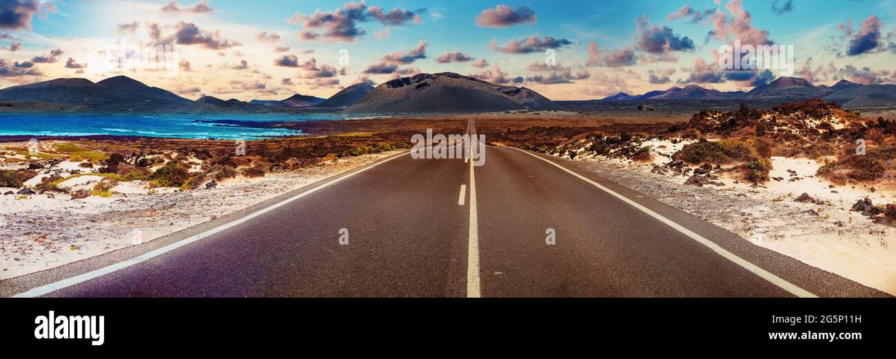 Road through the scenic landscape to the destination in Lanzarote natural park. Image related to unexplored road journeys and adventures Stock Photo