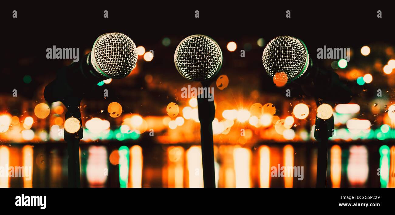 Live music and conference background.Karaoke and entertainment concept. Microphone and stage lights.Concert and music concept. Stock Photo