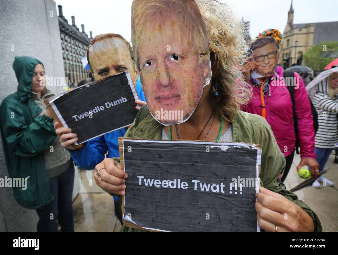 Protesters wearing Boris Johnson, Matt Hancock and Bill Gates masks hold placards during the demonstration.Anti-lockdown and anti-vaccination demonstrators held a protest against lockdown extension, masks and vaccination passports. Stock Photo