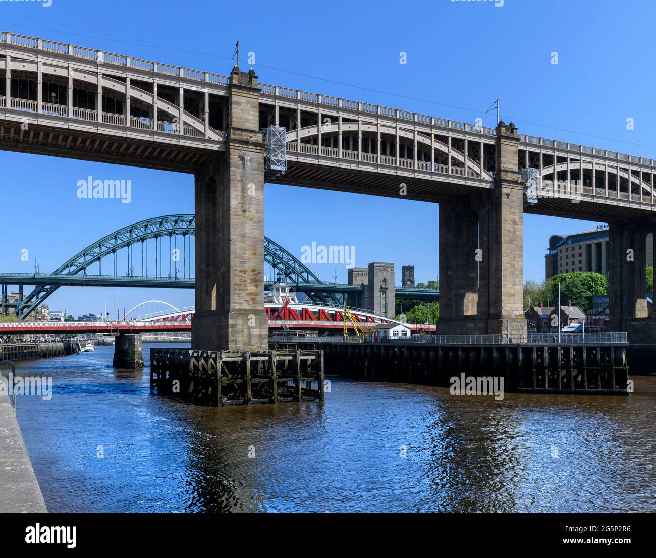 Three bridges linking Newcastle and Gateshead: Tyne, Swing and the High Level Bridge with two decks for pedestrians, buses and trains. Stock Photo