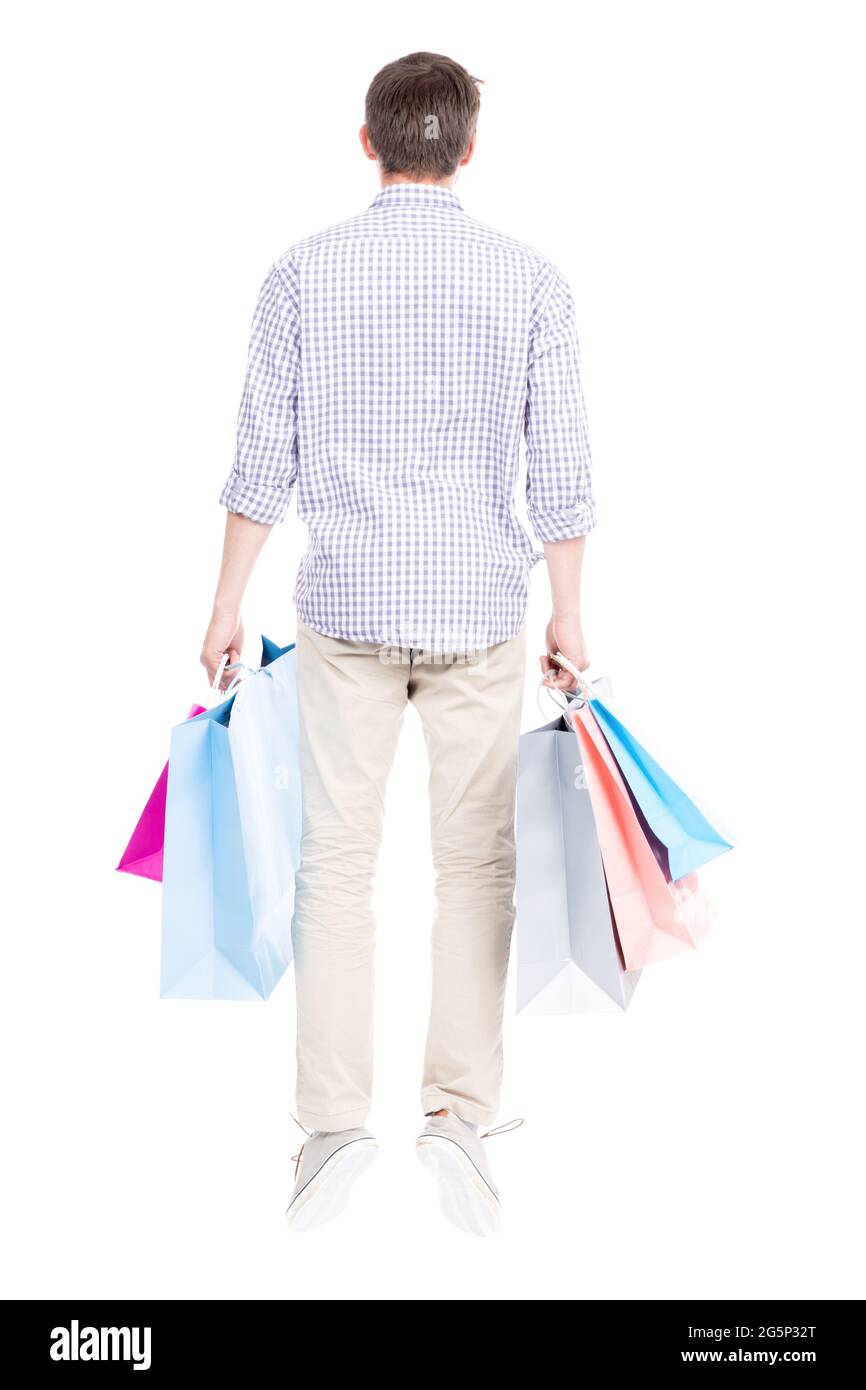 Studio portrait shot of young adult Caucasian man wearing casual clothes standing alone holding shopping bags, white background Stock Photo