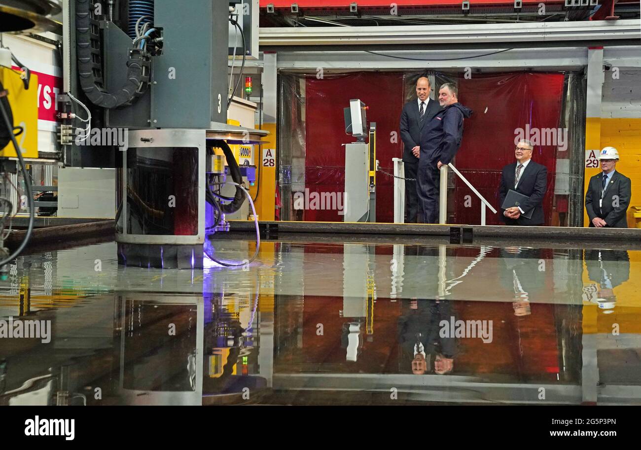 The Duke of Cambridge, known as the Earl of Strathearn in Scotland, watches with Alex Clark during a steel-cutting ceremony while on a visit to the BAE Systems shipyard in Glasgow to see construction on HMS Glasgow - the Royal Navy's first City-class Type 26 frigate. Picture date: Tuesday June 29, 2021. Stock Photo