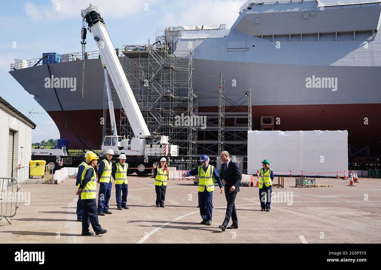 The Duke of Cambridge, known as the Earl of Strathearn in Scotland, talks with workers during a visit to the BAE Systems shipyard in Glasgow to see construction on HMS Glasgow (back of picture) - the Royal Navy's first City-class Type 26 frigate - as part of a visit to Scotland for Holyrood Week. Picture date: Tuesday June 29, 2021. Stock Photo