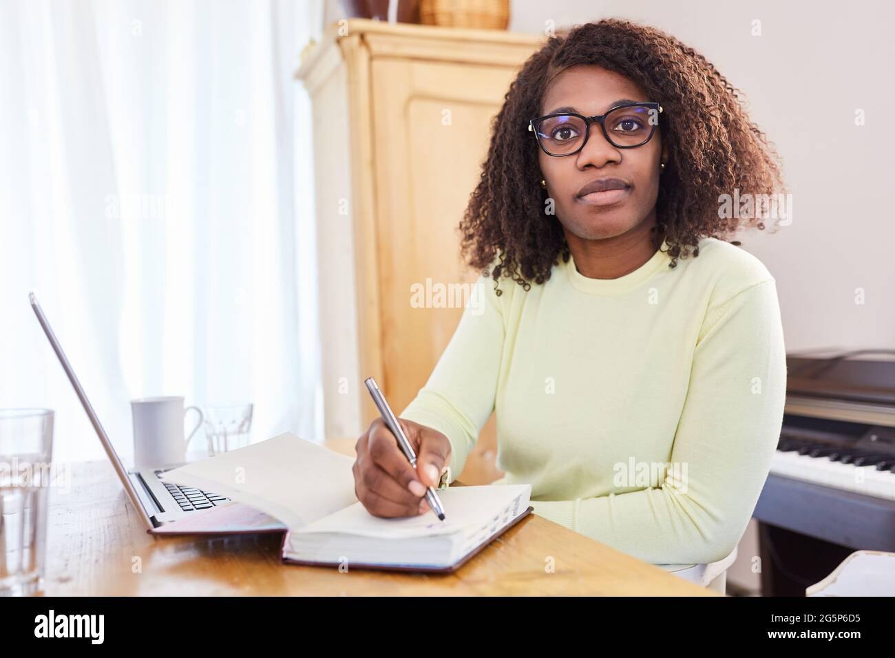 African American business woman working as a freelancer in the home ...