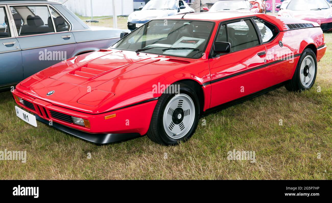 Three-quarters front view of a Red, 1980, BMW M1, on display at the 2021, London Classic Car Show, Syon Park Stock Photo