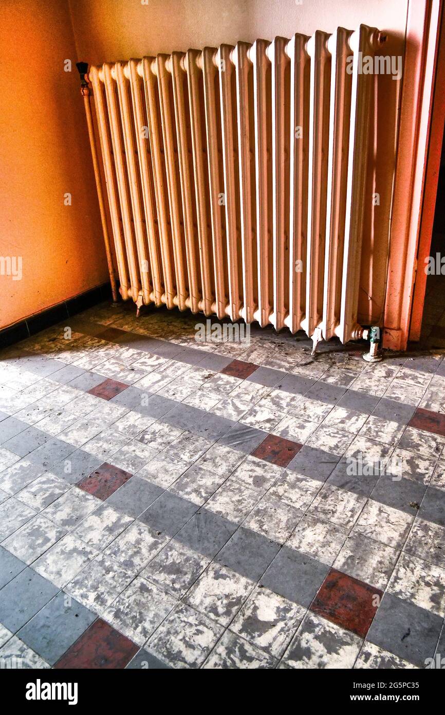 Radiator in the entrance hall of an abandoned house, Conceptual ...