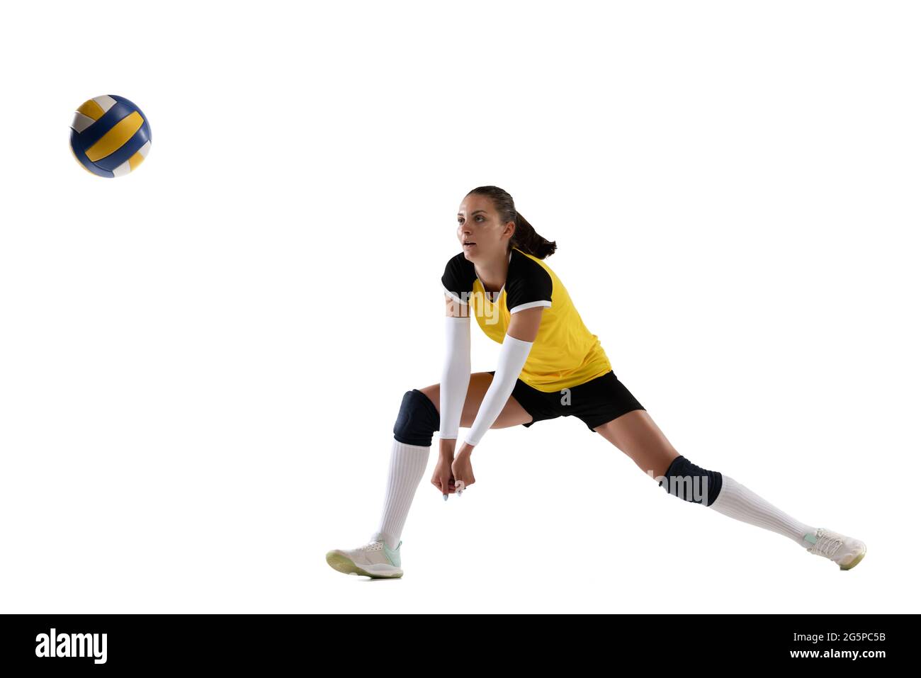 Female professional volleyball player with ball isolated on white