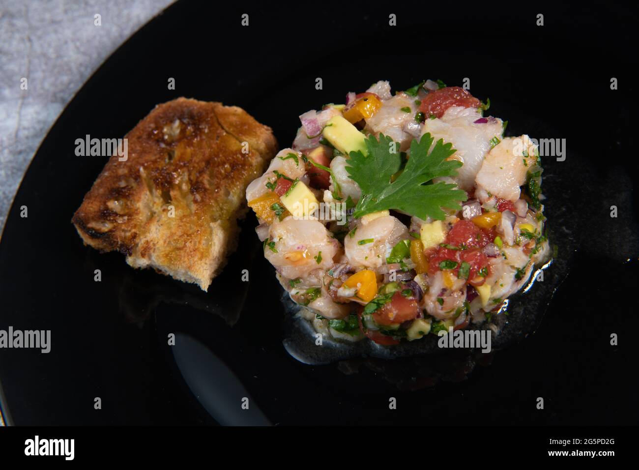 Cod Ceviche recipe, bread in oil and garlic Stock Photo Alamy