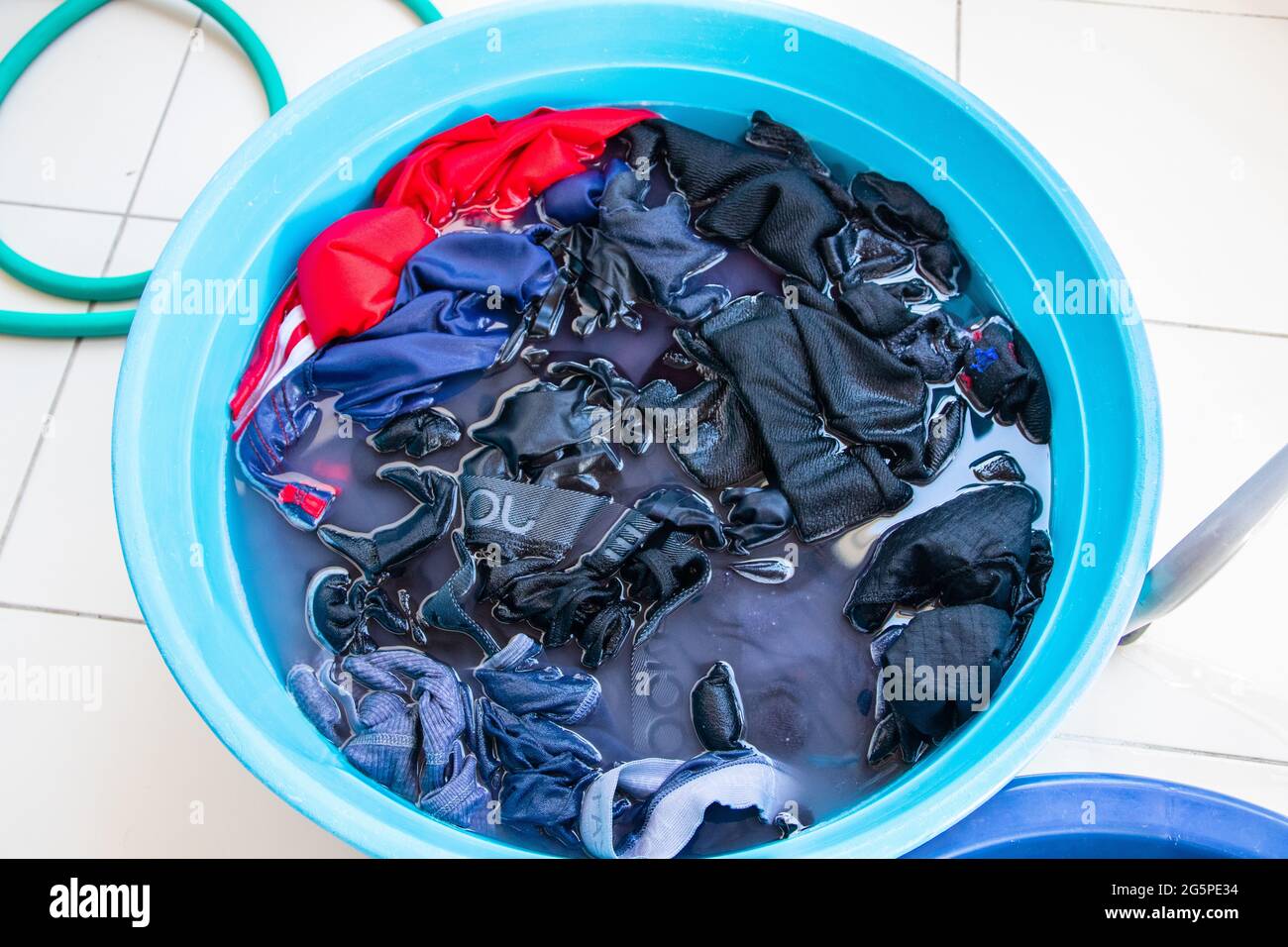 Laundry in a water bucket for prewash Stock Photo Alamy