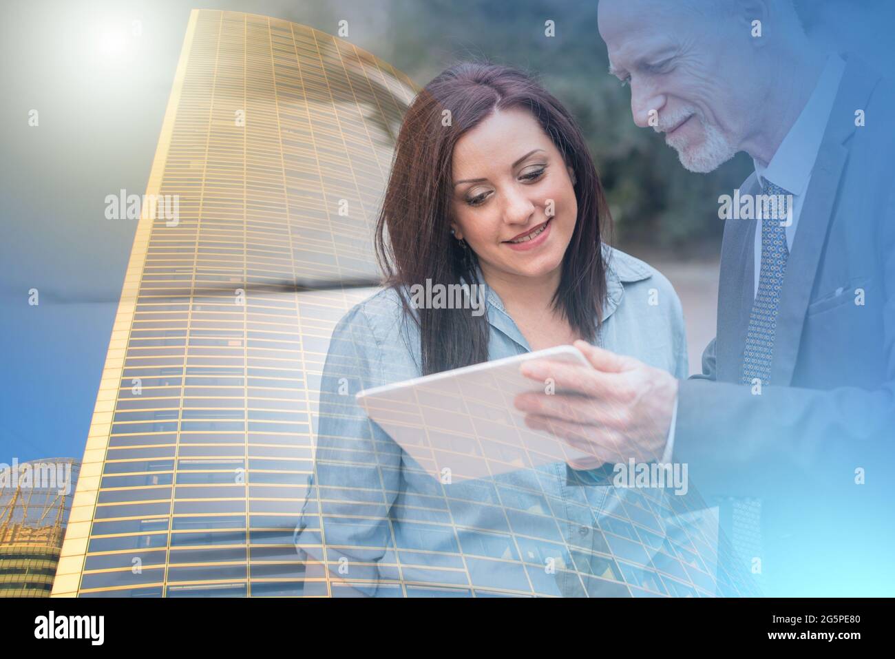 Car salesman giving informations on tablet to young woman outdoors; multiple exposure Stock Photo
