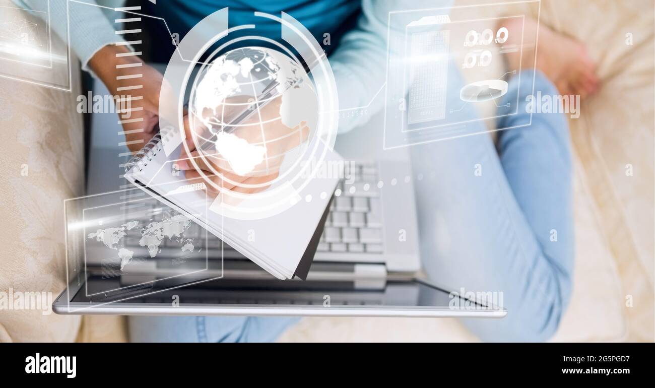 Composition of screen with digital data processing over woman writing using laptop Stock Photo