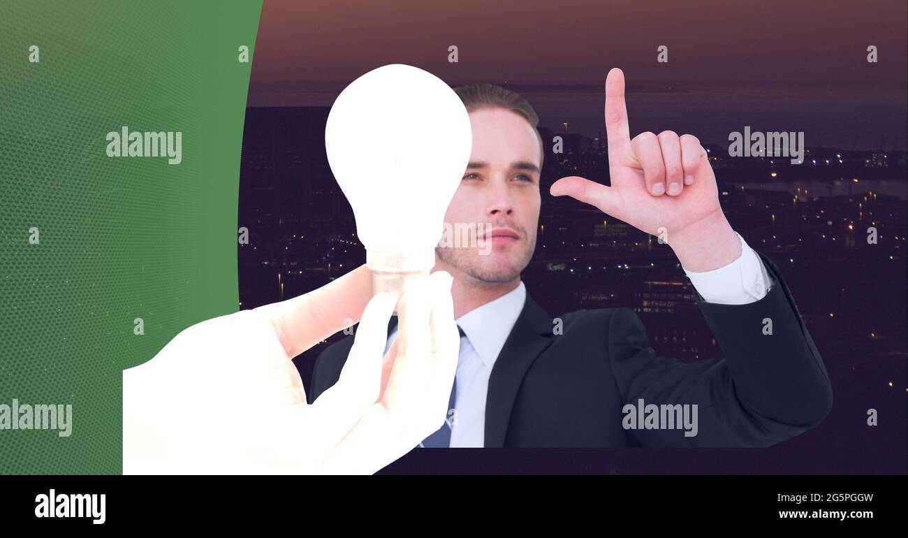 Composition of businessman touching interactive screen with lightbulb Stock Photo