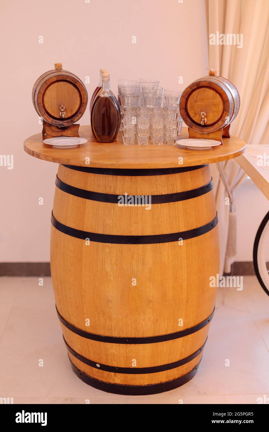 Traditional national bar with strong alcoholic beverages, made ine form of large barrel. Recreation and travel. Local alcohol. Festive events. Service Stock Photo