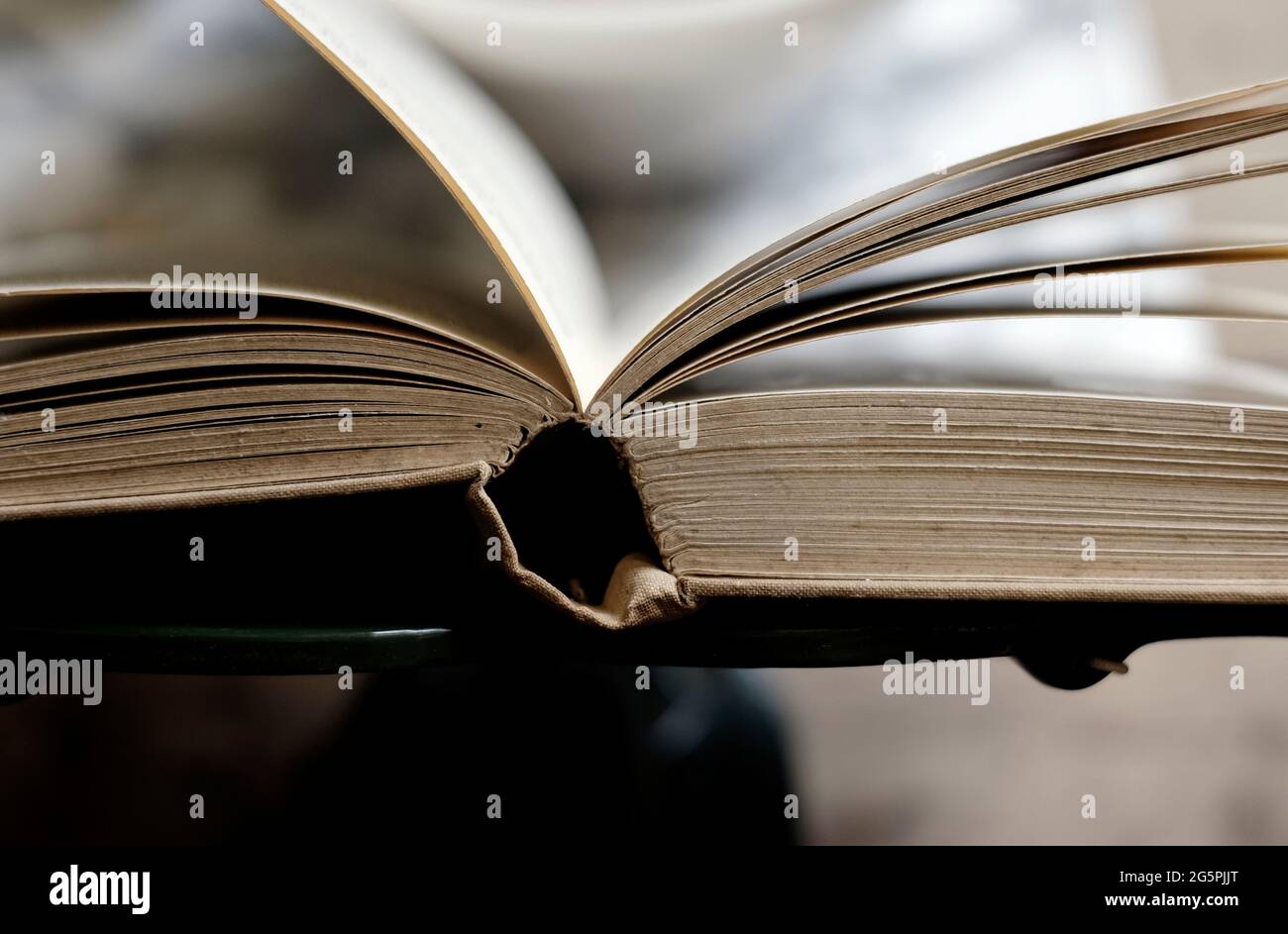 old book opened on lectern stand Stock Photo
