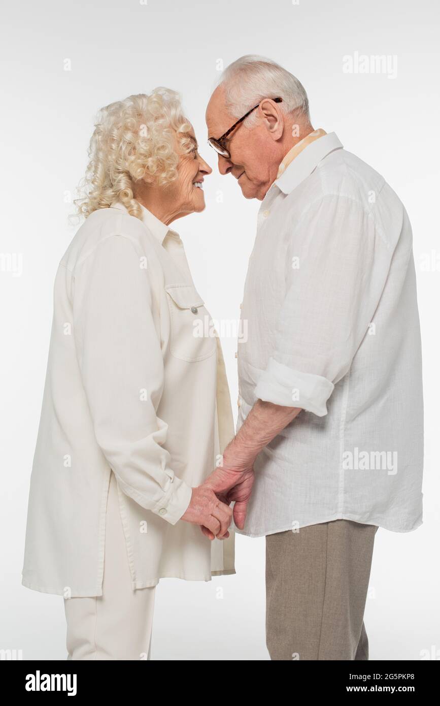 happy elderly couple in casual clothes standing with holding hands and ...