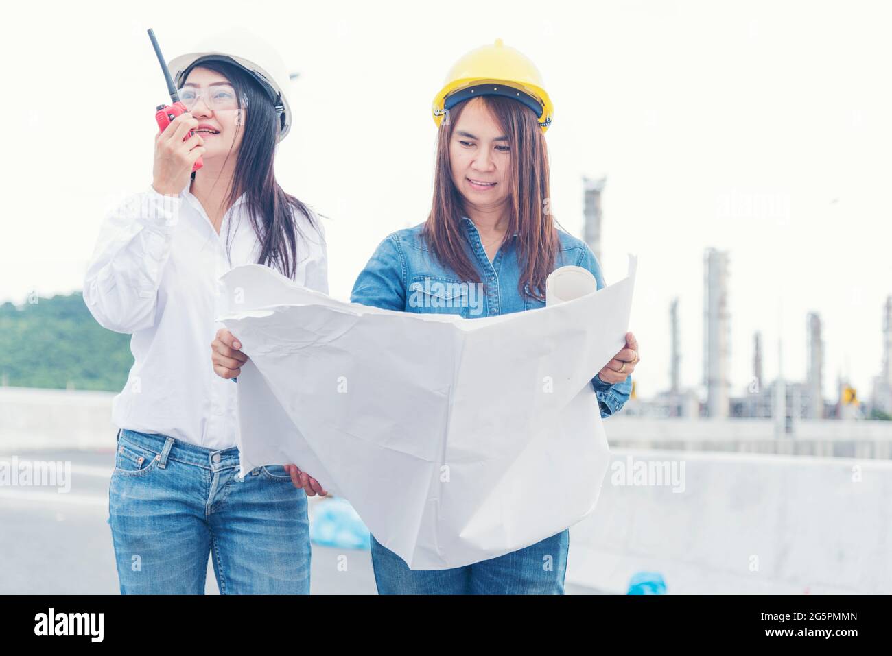 Civil Engineer Team holding blueprint plan for project on site working at railway track Manufacturing Industry Plant. Industry Engineering Concept. Stock Photo