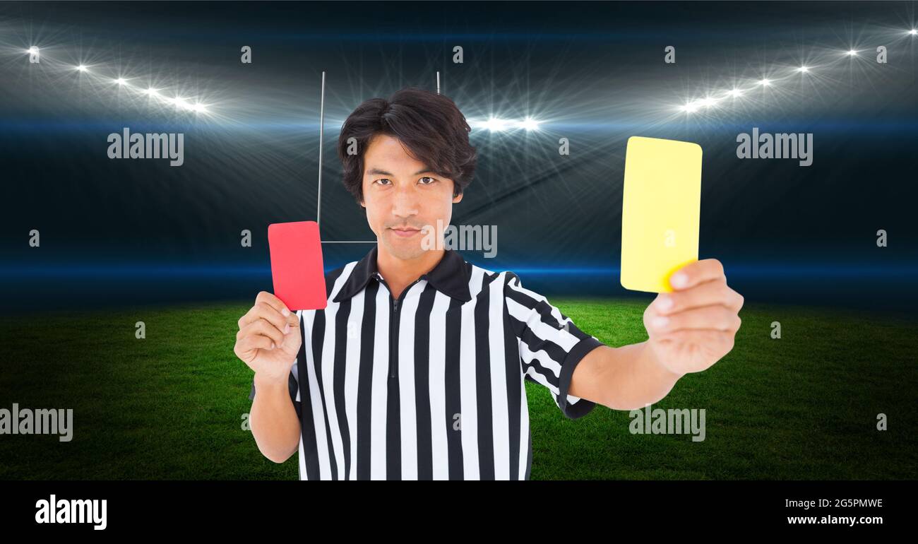 Composition of male referee holding red and yellow cards at stadium Stock Photo Alamy