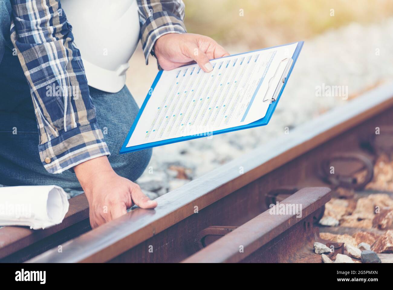 Civil Engineer Team holding blueprint plan for project on site working at railway track Manufacturing Industry Plant. Industry Engineering Concept. Stock Photo