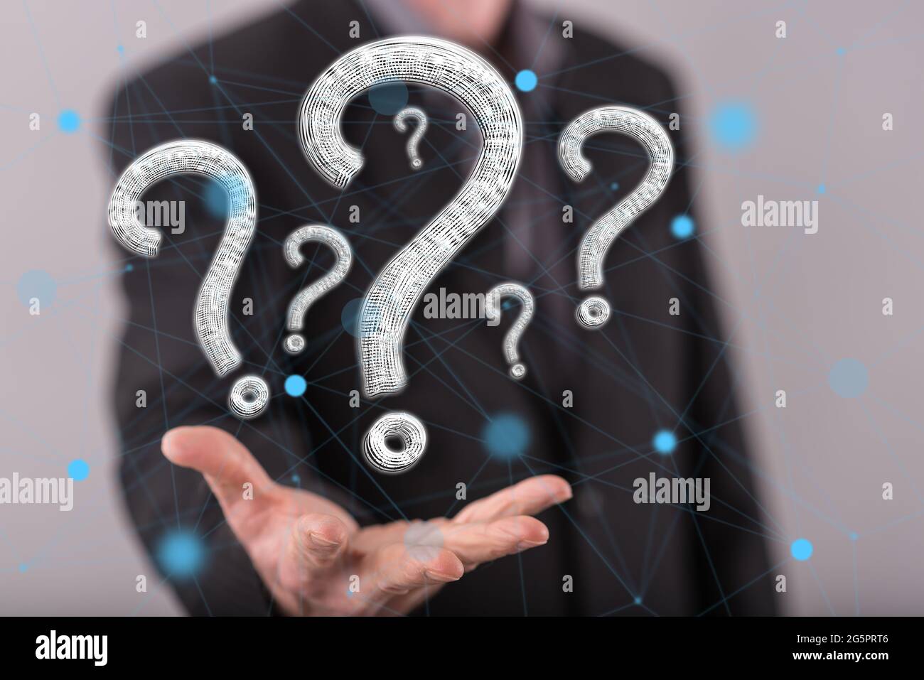 Question concept above the hand of a man in background Stock Photo