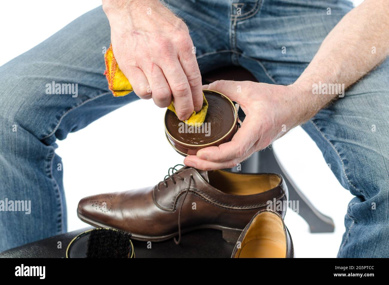 Shoe shiner putting shoe polish on a rag Stock Photo Alamy
