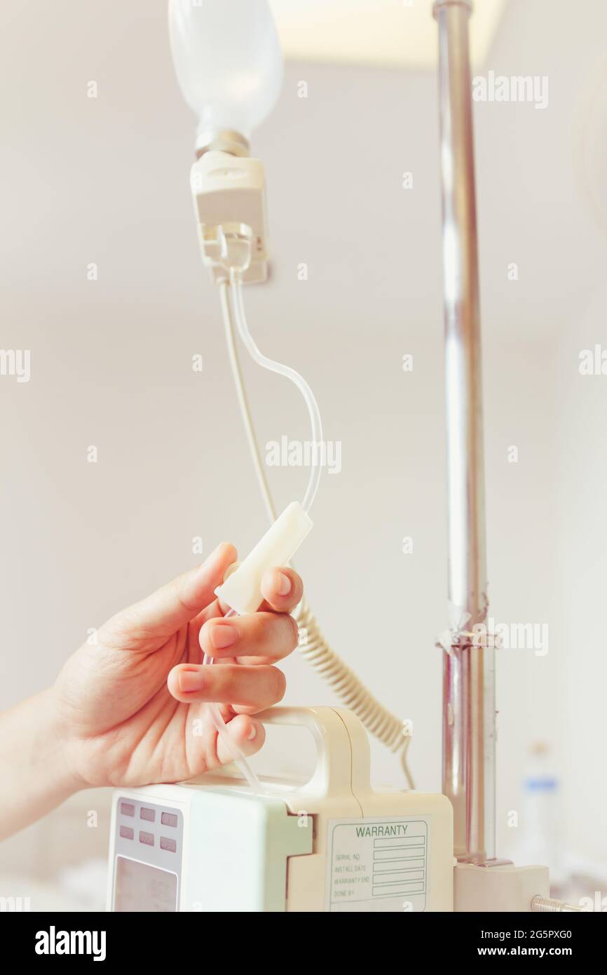 Nurse's hands regulation infusion pump intravenous (IV) drip in
