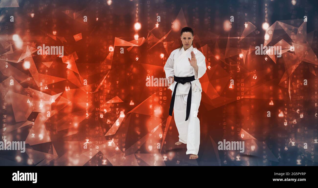 Caucasian female martial artist with black belt against plexus networks on blue background Stock Photo