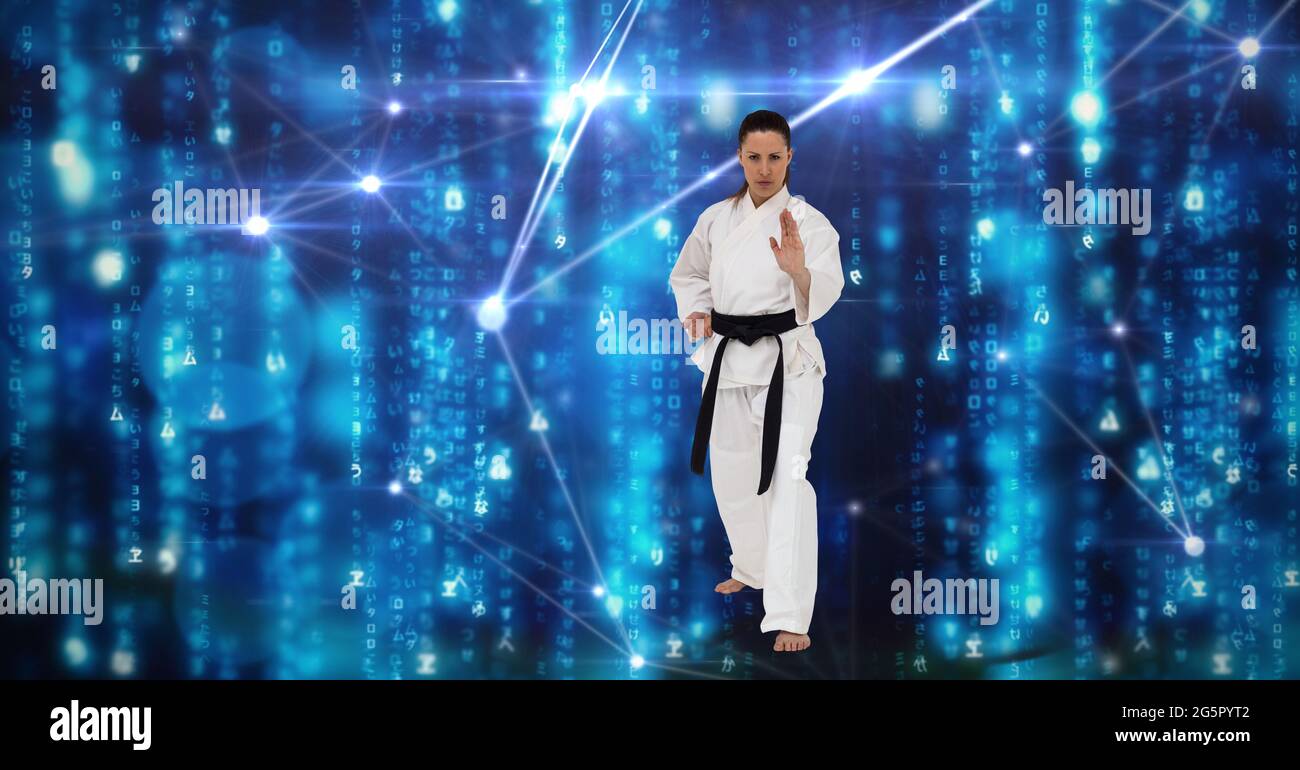 Caucasian female martial artist with black belt against network of connections on blue background Stock Photo