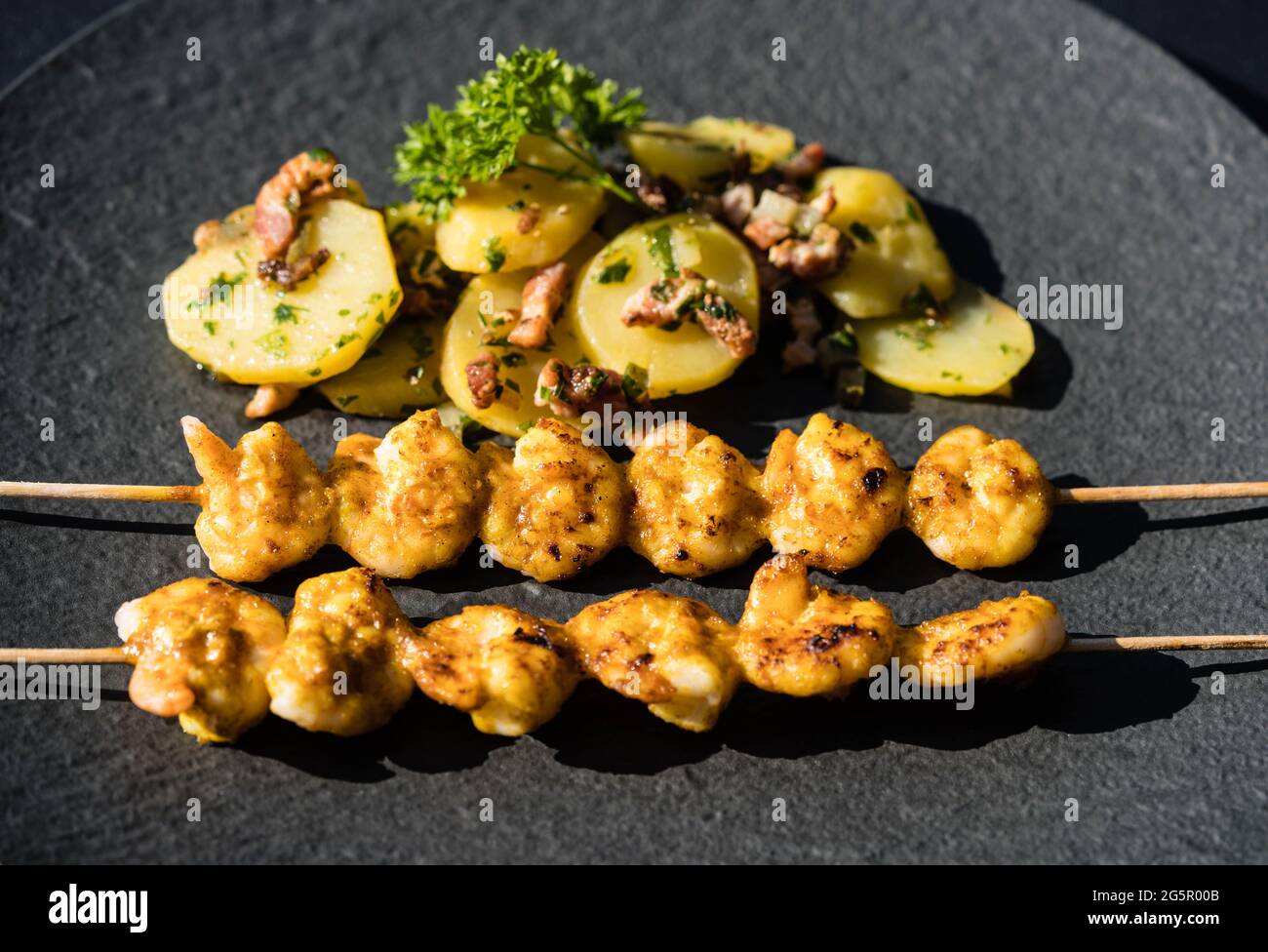 grilled White Tiger Prawns with Bacon Potato Salad Stock Photo