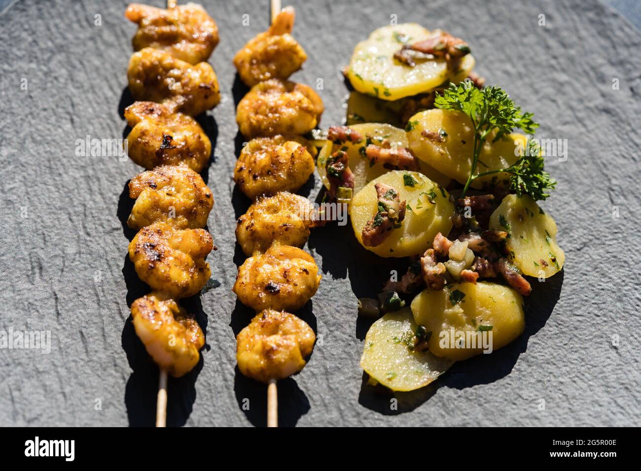 grilled White Tiger Prawns with Bacon Potato Salad Stock Photo