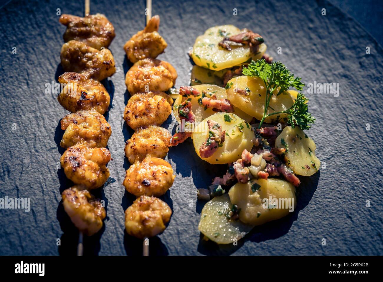 grilled White Tiger Prawns with Bacon Potato Salad Stock Photo